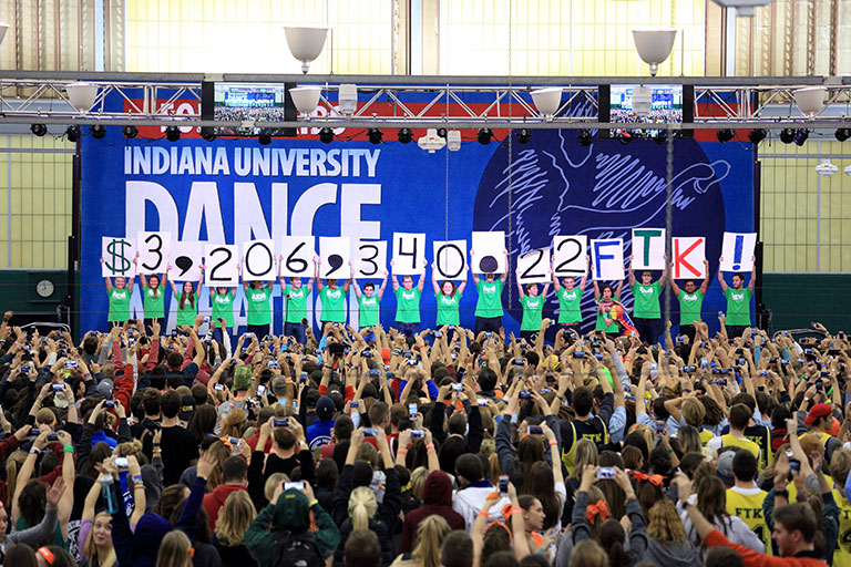IU Dance Marathon participants hold up signs indicating they raised $3,206,340 for Riley Hospital.